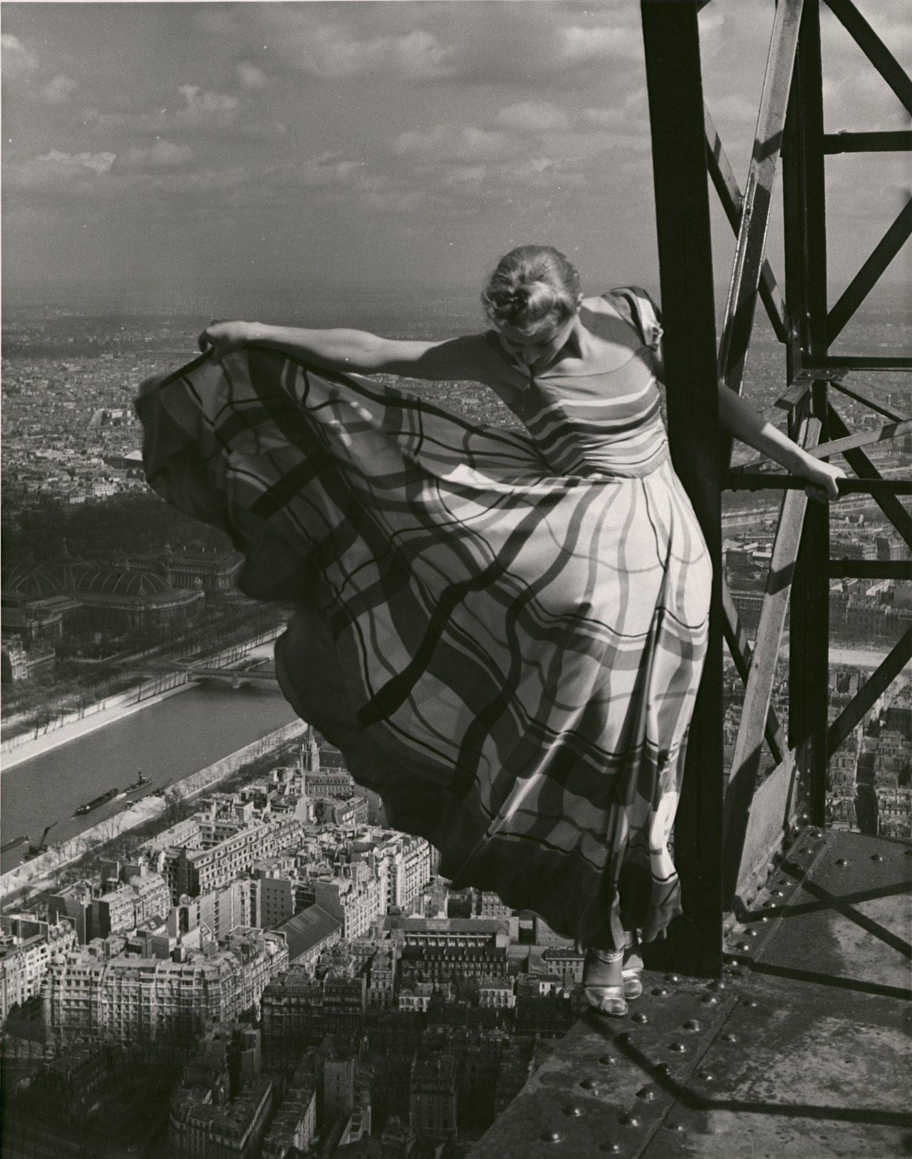 Lisa Fonssagrives wearing a Lucien Lelong dress high atop the Eiffel Tower by Erwin Blumenfeld 1939